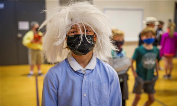 A boy dressed a scientist